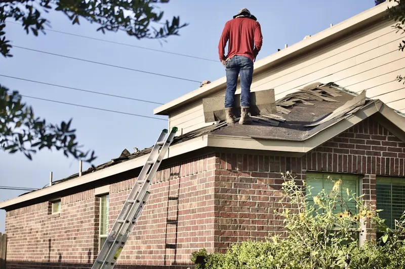 Professional roofer working on a residential roof in Jan Phyl Village